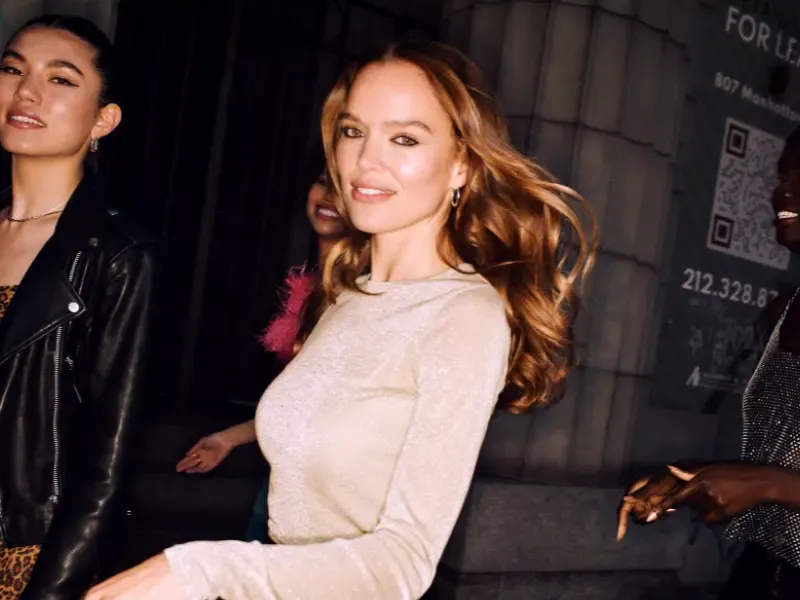 At home blowout giving a woman soft, voluminous waves as she walks confidently with friends during a night out