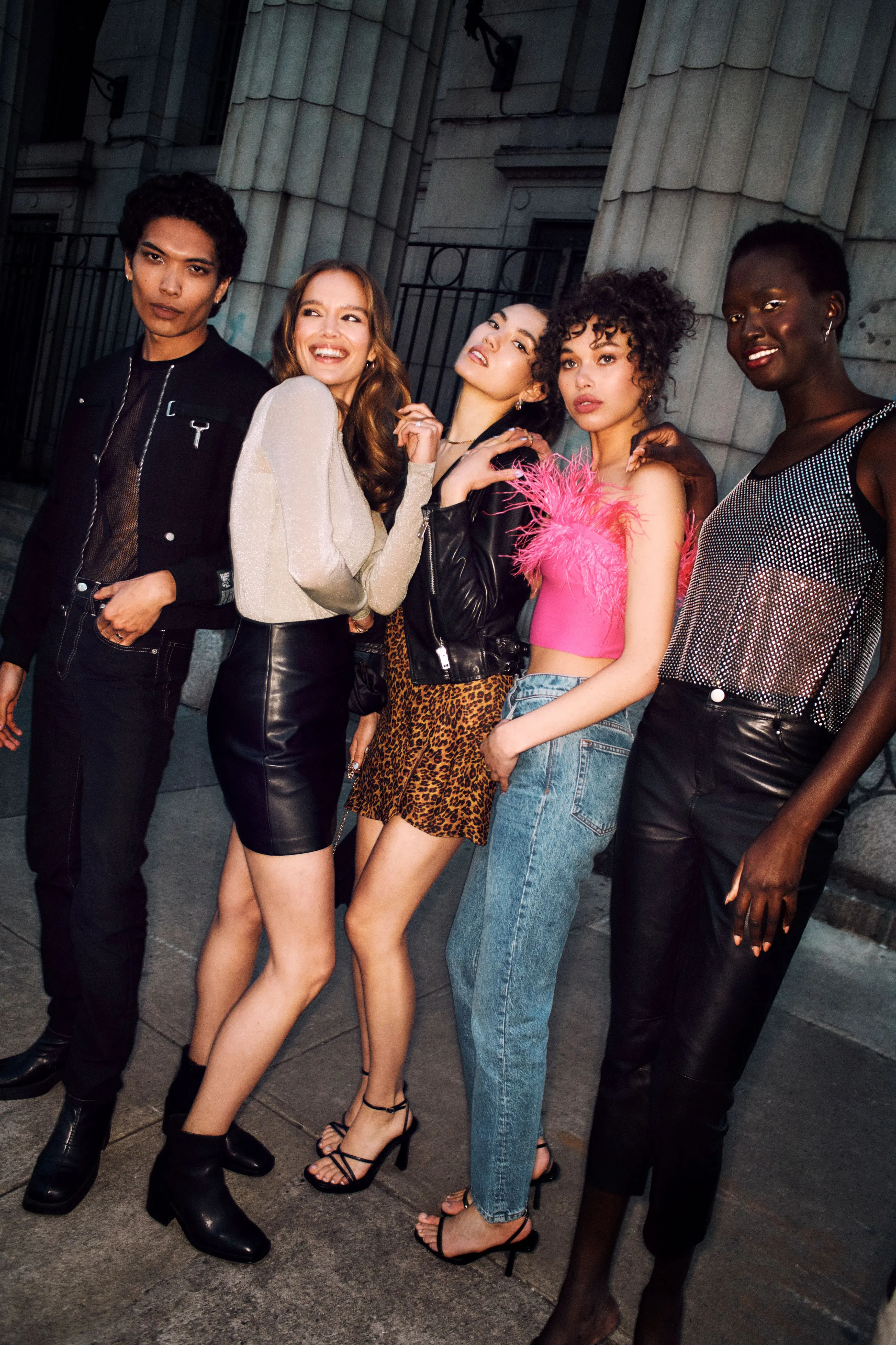 Makeup services for a diverse group of five friends in edgy night-out outfits posing together on a New York City street at night.